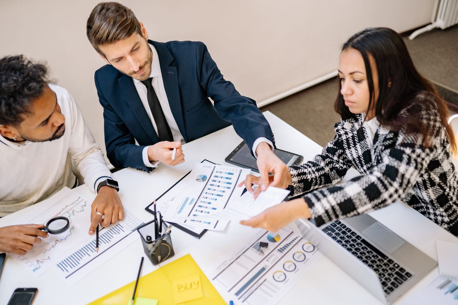 Marketing team collaborating on social media strategy around a table